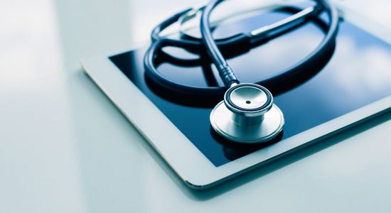 Medical Equipment On Table. Blue Stethoscope And Tablet On White Medical equipment on table. Blue stethoscope and tablet on white background.